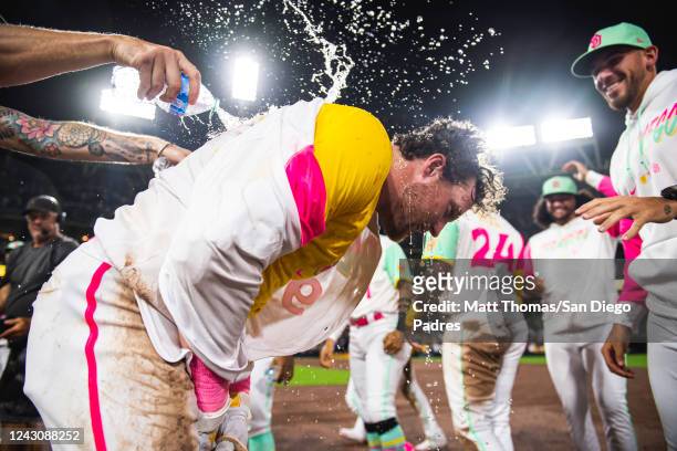 Mike Clevinger of the San Diego Padres douses Jake Cronenworth with water after defeating the Los Angeles Dodgers at PETCO Park on September 9, 2022...