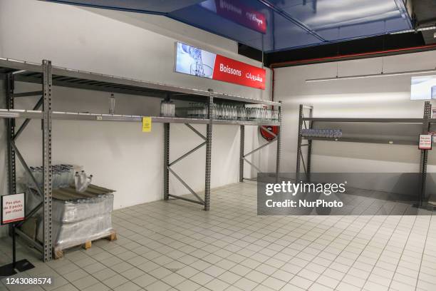 Shelves of bottles of mineral water and milk are empty in a supermarket in Ariana, suburb of Tunis, Tunisia, on September 9 as since several weeks...