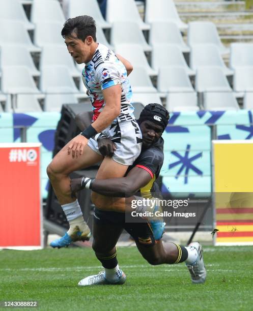 Jeong Yeonsik of Korea tackled by Michael Okorach of Uganda during Men's Bowl Quarter Finals match between Uganda and Korea on day 2 of the Rugby...