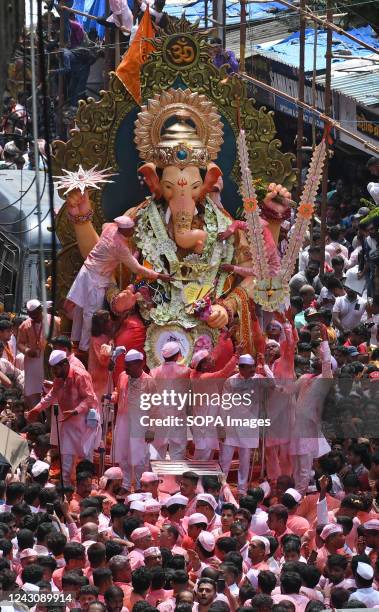 Devotees carry an idol of elephant-headed Hindu god Ganesh during the immersion procession. Anant Chaturdashi marks the end of a ten day festival of...