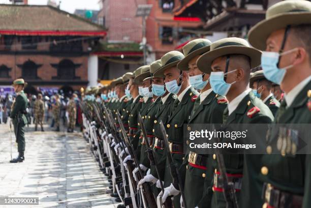 Army personnel parade during the procession in Hanuman Dhoka Durbar Square. People celebrate Indra Jatra festival to honor Indra, king of heaven and...