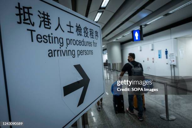 Sign guiding the arrivals in the Hong Kong International Airport to walk to the COVID testing area. As countries across the globe ease quarantine...