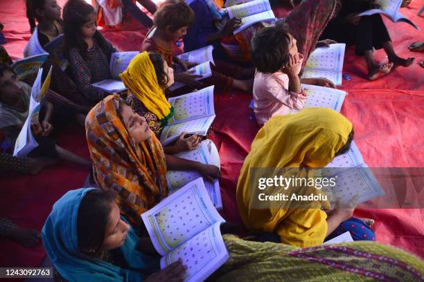 Displaced Pakistani flood victims children attend their class as they study at a Temporary Learning Centre for flood affected area of children...