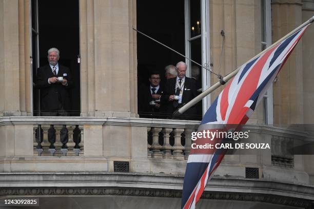 People drink cups of tea during the Proclamation of Britain's new King, King Charles III, at St James Palace, in London, on September 10, 2022. King...