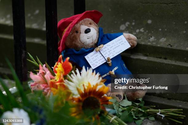 Small Paddington Bear toy and message is left amongst flowers and tributes outside the Palace of Holyroodhouse in tribute to Queen Elizabeth II on...