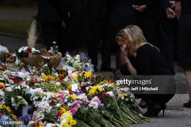 Lady Louise Windsor and Sophie, Countess of Wessex look at floral tributes outside at Crathie Kirk church on September 10, 2022 in Crathie near...