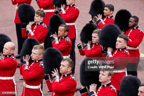Members of the Coldstream Guards raise their Bearskin hats as they salute the new King, following the proclamation of King Charles III at St James's...