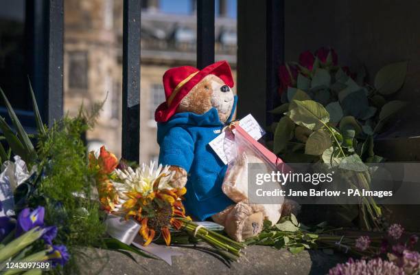 Paddington Bear toy and marmalade sandwich is left amongst flowers and tributes outside the Palace of Holyroodhouse, Edinburgh, following the death...