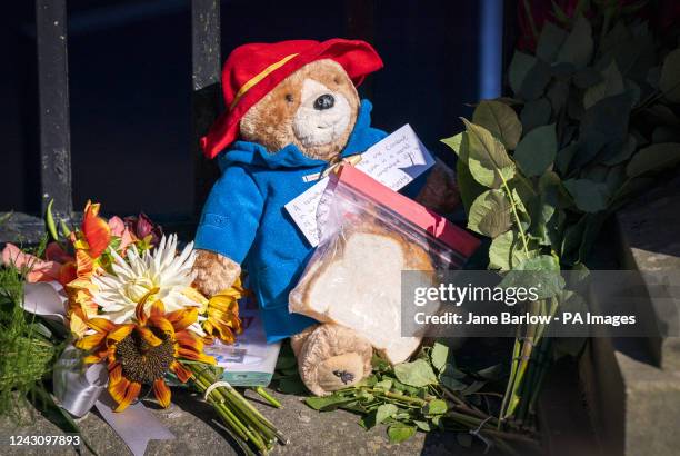 Paddington Bear toy and marmalade sandwich is left amongst flowers and tributes outside the Palace of Holyroodhouse, Edinburgh, following the death...