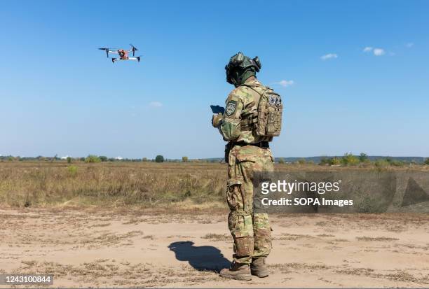 Drone operator launches a quadcopter to monitor the operation of an evacuation robot during its field testing. Field tests of THeMIS multi-purpose...
