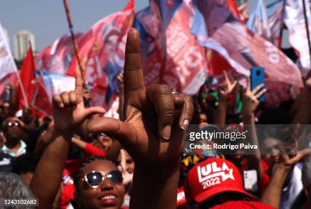 Supporters of Brazil's former president and current presidential candidate Luiz Inacio Lula da Silva attend to a campaign rally ahead of October 02...
