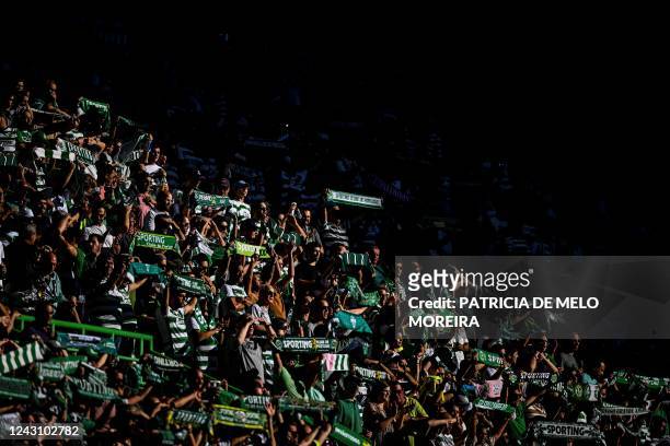 Sporting's supporters hold scarves during the Portuguese League football match between Sporting CP and Portimonense SC at Alvalade stadium in Lisbon...