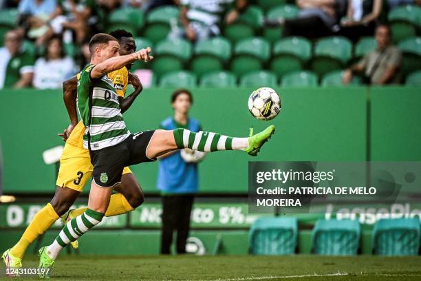 Sporting's Portuguese forward Nuno Santos vies with Portimonense's Ivorian defender Zie Ouattara during the Portuguese league football match between...