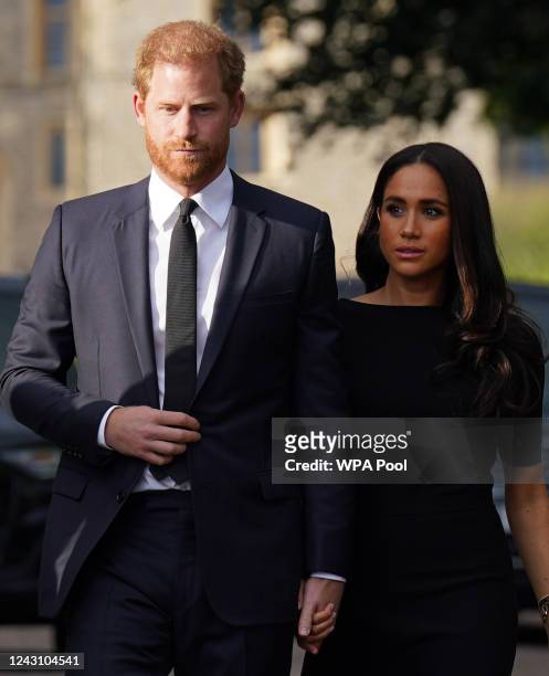Prince Harry, Duke of Sussex, and Meghan, Duchess of Sussex walk together to meet members of the public on the long Walk at Windsor Castle on...