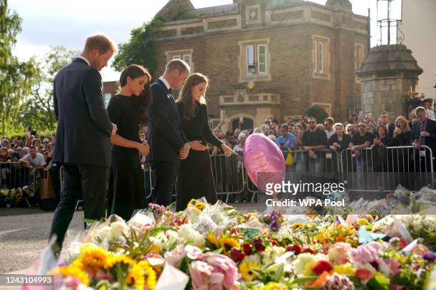 Prince Harry, Duke of Sussex, Meghan, Duchess of Sussex, Catherine, Princess of Wales and Prince William, Prince of Wales view floral tributes left...