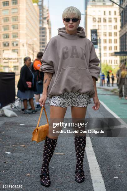 Veronica Guilty is seen wearing a Yeezy Gap Baleciaga hoodie, dress by Reformation, shoes Marine Serre and a bag by Jacquemus to NYFW at Spring...