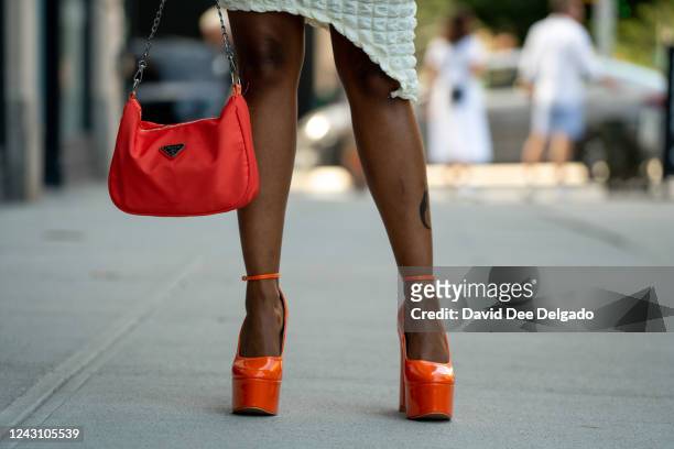 Tae Cimone is seen wearing a dress by In Seam by Julia Shardae, shoes by Ego and a Prada hand bag to NYFW at Spring Studios on September 10, 2022 in...