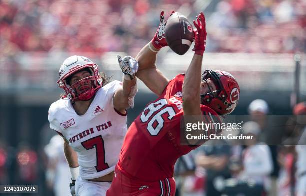 Dalton Kincaid of the Utah Utes pulls in a pass against Mitch Price of the Southern Utah Thunderbirds during the first half of their game September...