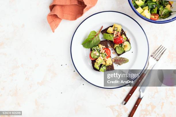 avocado tomato salad on rye bread toast - rye bread stock pictures, royalty-free photos & images