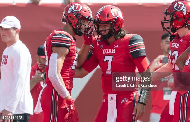 Cameron Rising of the Utah Utes celebrates a touchdown with teammate Brant Kuithe during the first half of their game against the Southern Utah...