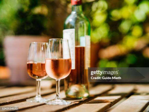 glass of wine on a table in sunlight. - empty wine glass stock-fotos und bilder