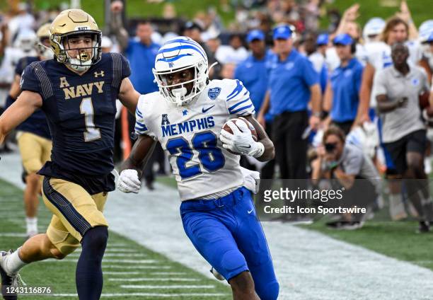 Memphis Tigers running back Asa Martin breaks off a long run and is forced out of bounds at the one yard line by Navy Midshipmen linebacker John...