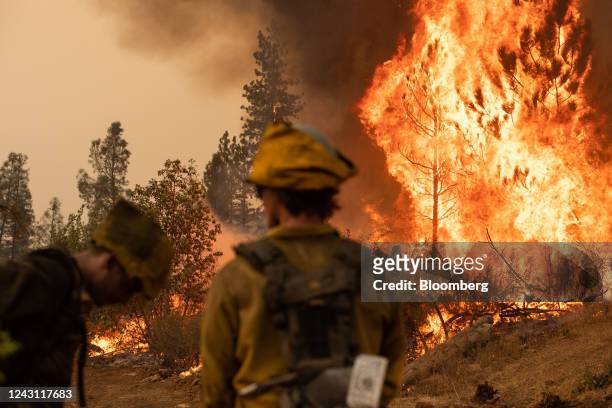 Firefighters watch a backfire operation during the Mosquito fire near Volcanoville, California, US, on Friday, Sept. 9, 2022. The wildfire, which...
