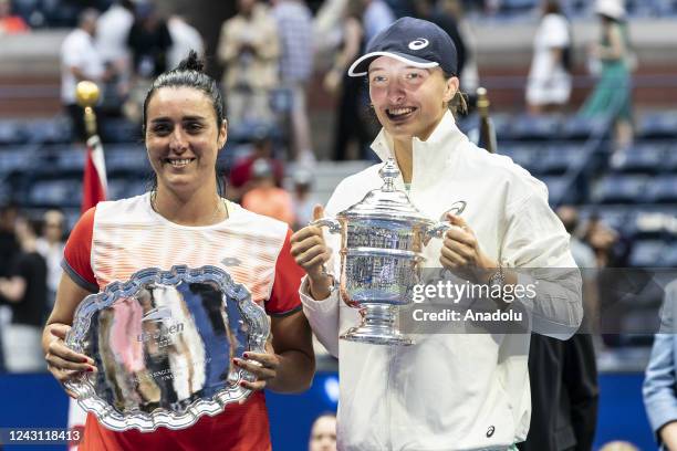 Iga Swiatek of Poland and Ons Jabeur hokld their trophies final of US Open Championships won by Swiatek at USTA Billie Jean King National Tennis...