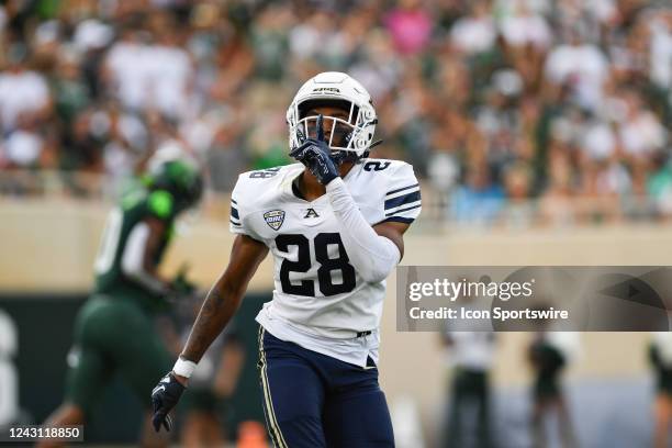 Akron Zips defensive back Tyson Durant quiets the crowd after a pass break up during a college football game between the Michigan State Spartans and...