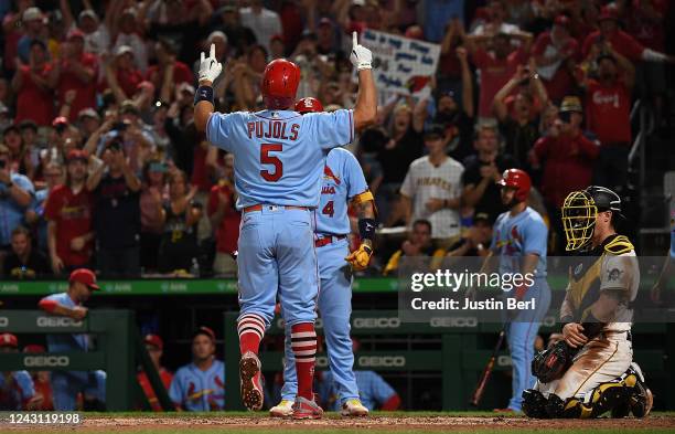 Albert Pujols of the St. Louis Cardinals reacts at home plate after hitting a two run home run in the sixth inning during the game against the...