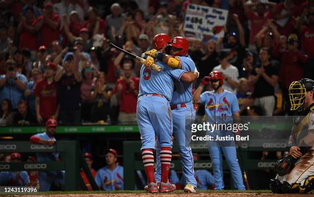 Albert Pujols of the St. Louis Cardinals is hugged by Yadier Molina at home plate after hitting a two run home run in the sixth inning during the...