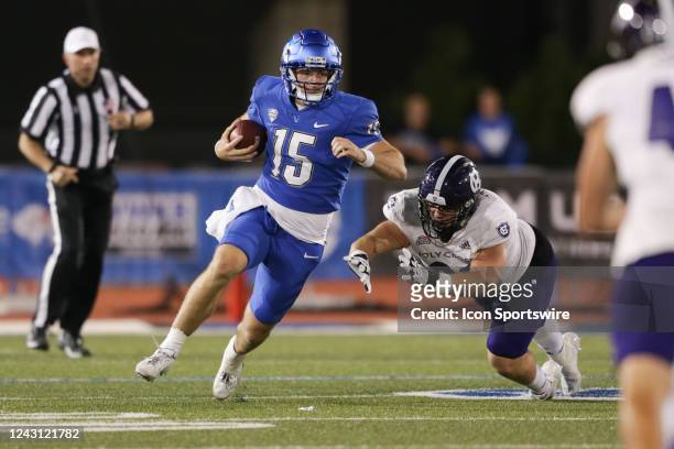 Buffalo Bulls quarterback Cole Snyder scrambles away from Holy Cross Crusaders defensive lineman Dillon Springer during the fourth quarter of a...