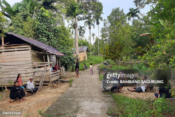 People gather outside their homes following an earthquake off Indonesia's Mentawai Islands, at Muara Sikabaluan village in Siberut Utara, West...