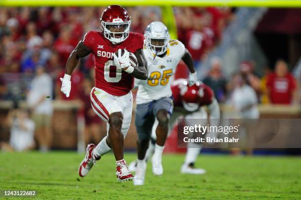 Running back Eric Gray of the Oklahoma Sooners runs for a 44-yard gain against defensive back D.J. Miller, Jr. #35 of the Kent State Golden Flashes...