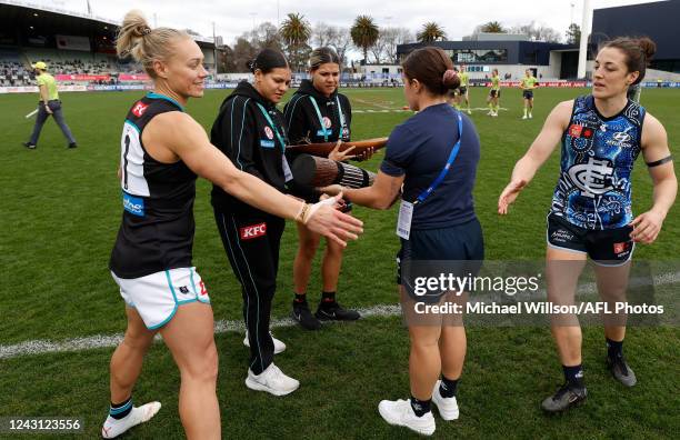 Gifts are exchanged during the 2022 S7 AFLW Round 03 match between the Carlton Blues and the Port Adelaide Power at Ikon Park on September 11, 2022...