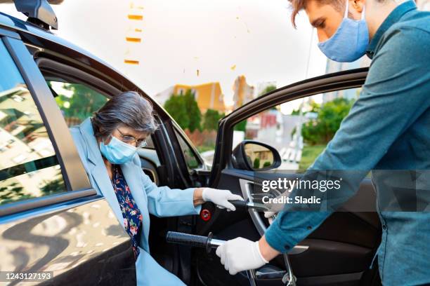 senior women in a car with caregiver - car assistance stock pictures, royalty-free photos & images