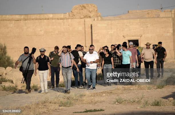 Group of tourists visit the ancient city of Hatra in northern Iraq on September 10 as local authority initiatives seek to encourage tourism and turn...