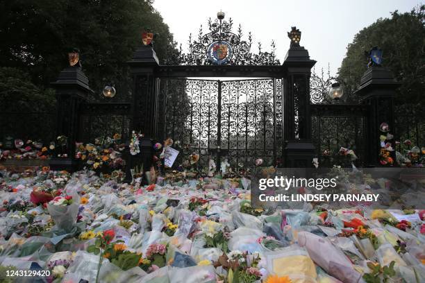 Floral tributes are pictured at the Norwich Gate outside the Sandringham Estate in Sandringham, Norfolk, eastern England, on September 11 following...