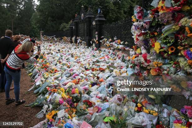 Well-wishers view floral tributes left at the Norwich Gate outside the Sandringham Estate in Sandringham, Norfolk, eastern England, on September 11...