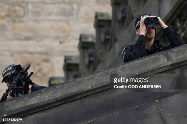 Police officers with snipers stand on the roof of St Giles' Cathedral in Edinburgh on September 11 where Queen Elizabeth II will lie at rest. Queen...