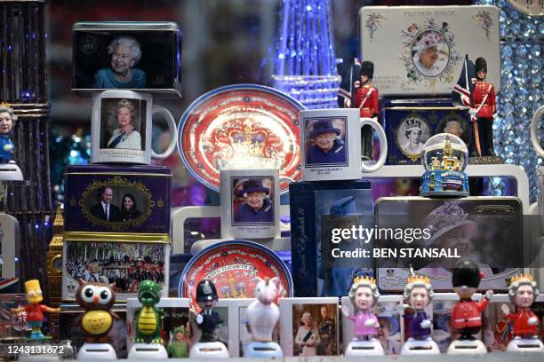 Souvenirs of the late Queen Elizabeth II are seen in a window of a shop in Canterbury, in south-east England on September 11 following the death of...