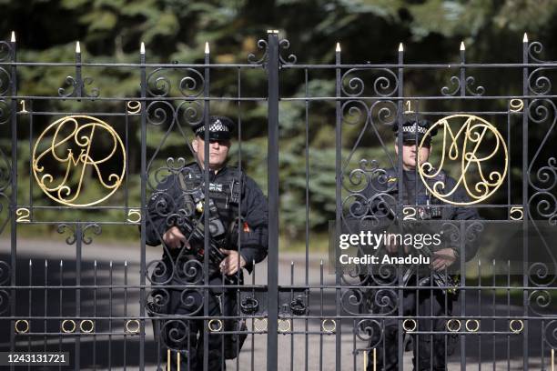 Police officers stand guarded at Balmoral Castle after funeral cortege carrying the coffin of Queen Elizabeth II leaves before arriving at the Palace...
