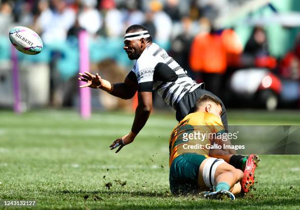 Sevuloni Mocenacagi of Fiji offloads the ball during day 3 of the Rugby World Cup Sevens 2022 Match 40 Championship Semi Finals between Australia and...