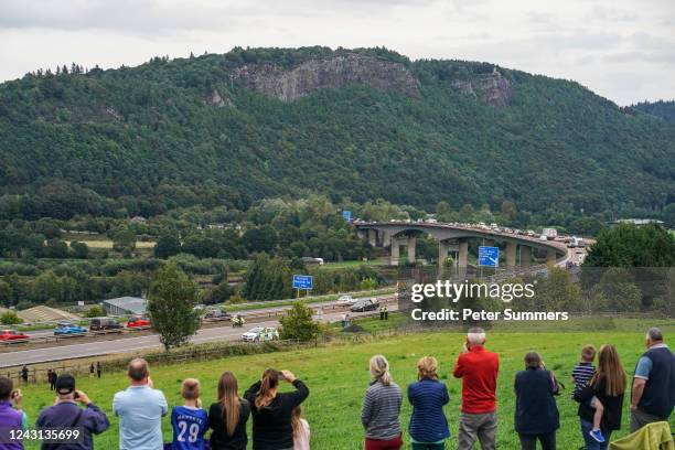 People gather in tribute as the cortege carrying the coffin of the late Queen Elizabeth II passes on September 11, 2022 near Perth, United Kingdom....