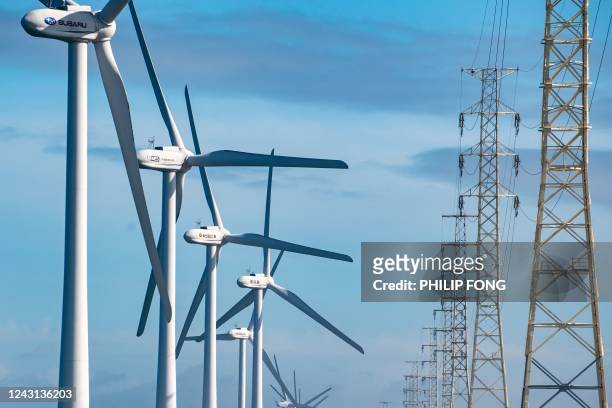 Wind turbines generate electricity at the seaside in Kamisu, Ibaraki prefecture on September 11, 2022.