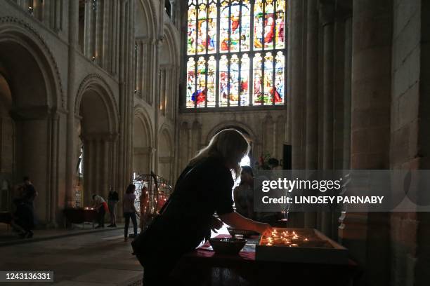 Candle is lit in Norwich Cathedral in eastern England, on September 11 following the death of the late Britain's Queen Elizabeth II. Queen Elizabeth...