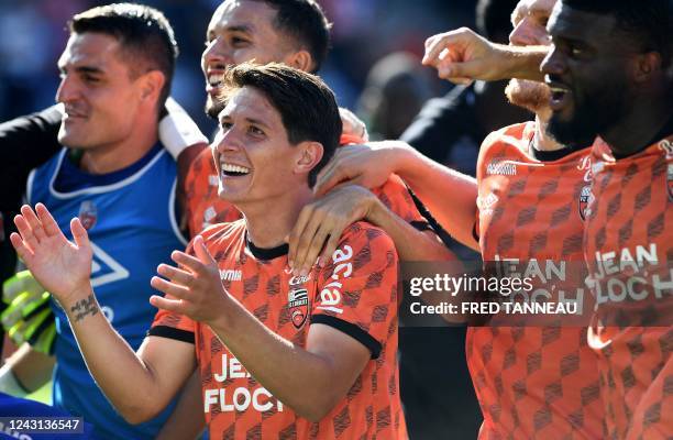 Lorient's French midfielder Laurent Abergel celebrates with teammates after their victory over Nantes at the end of the French L1 football match...