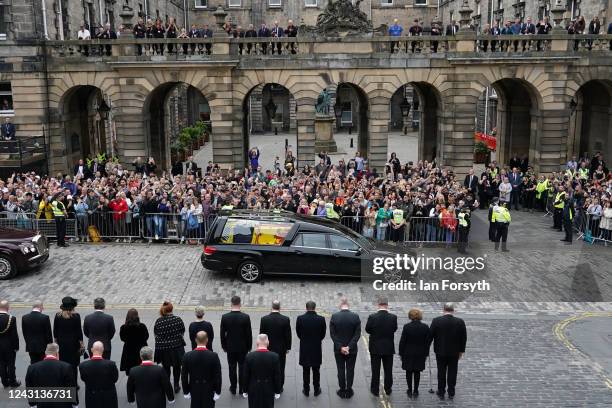 Crowds watch the cortege carrying the coffin of the late Queen Elizabeth II by Mercat Cross on September 11, 2022 in Edinburgh, United Kingdom....