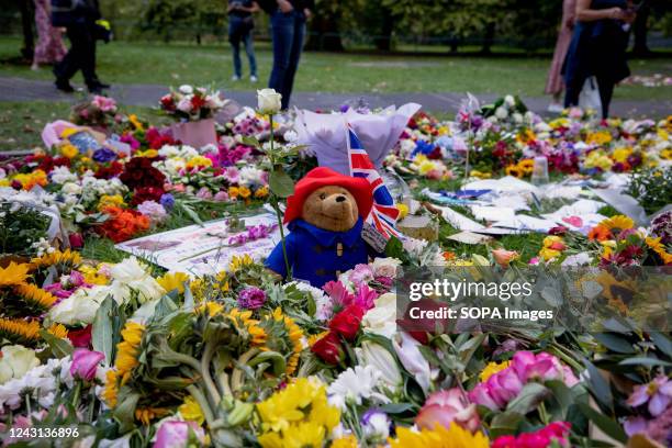 Messages and a Paddington bear to Queen Elizabeth II seen on top of the flower tributes at the designated area in Green Park. Thousands came to pay...