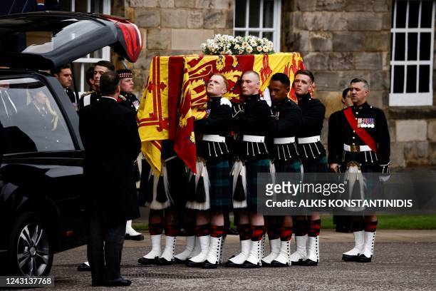 Pallbearers carry the coffin of late Britain's Queen Elizabeth II covered with the Royal Standard of Scotland, at the Palace of Holyroodhouse, in...